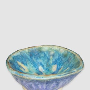 Australian-made ceramic bowl by Kattu, featuring a predominantly white glaze with a striking blue design reminiscent of ocean waves.