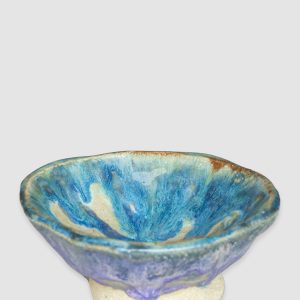 Australian-made ceramic bowl by Kattu, featuring a predominantly white glaze with a striking blue design reminiscent of ocean waves.