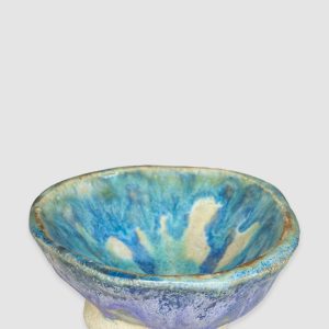 Australian-made ceramic bowl by Kattu, featuring a predominantly white glaze with a striking blue design reminiscent of ocean waves.