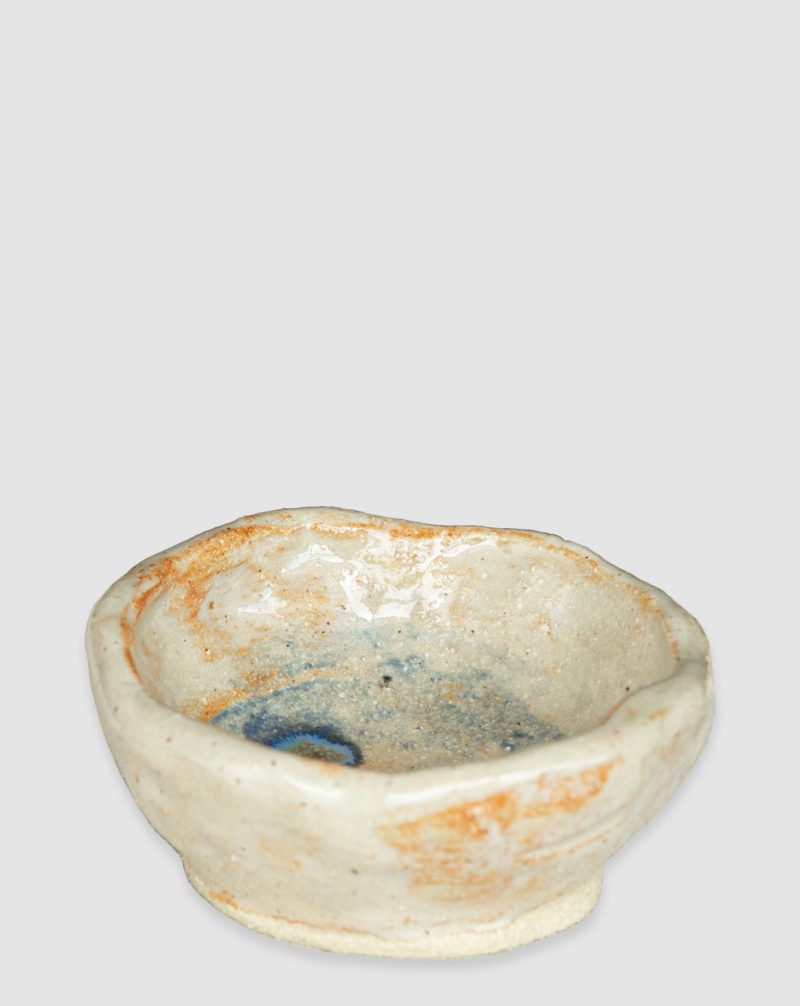 Handmade Australian ceramic bowl with an earthy neutral glaze and subtle blue accents, perfect for everyday use.