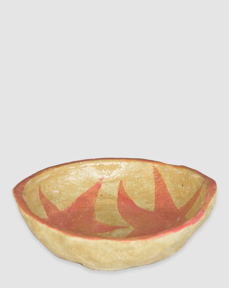 Australian-made ceramic bowl with a natural burnt glaze background and hand-painted red-pink stars connected in an artistic design.