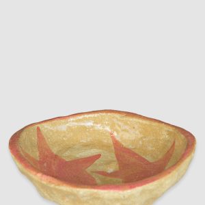 Australian-made ceramic bowl with a natural burnt glaze background and hand-painted red-pink stars connected in an artistic design.